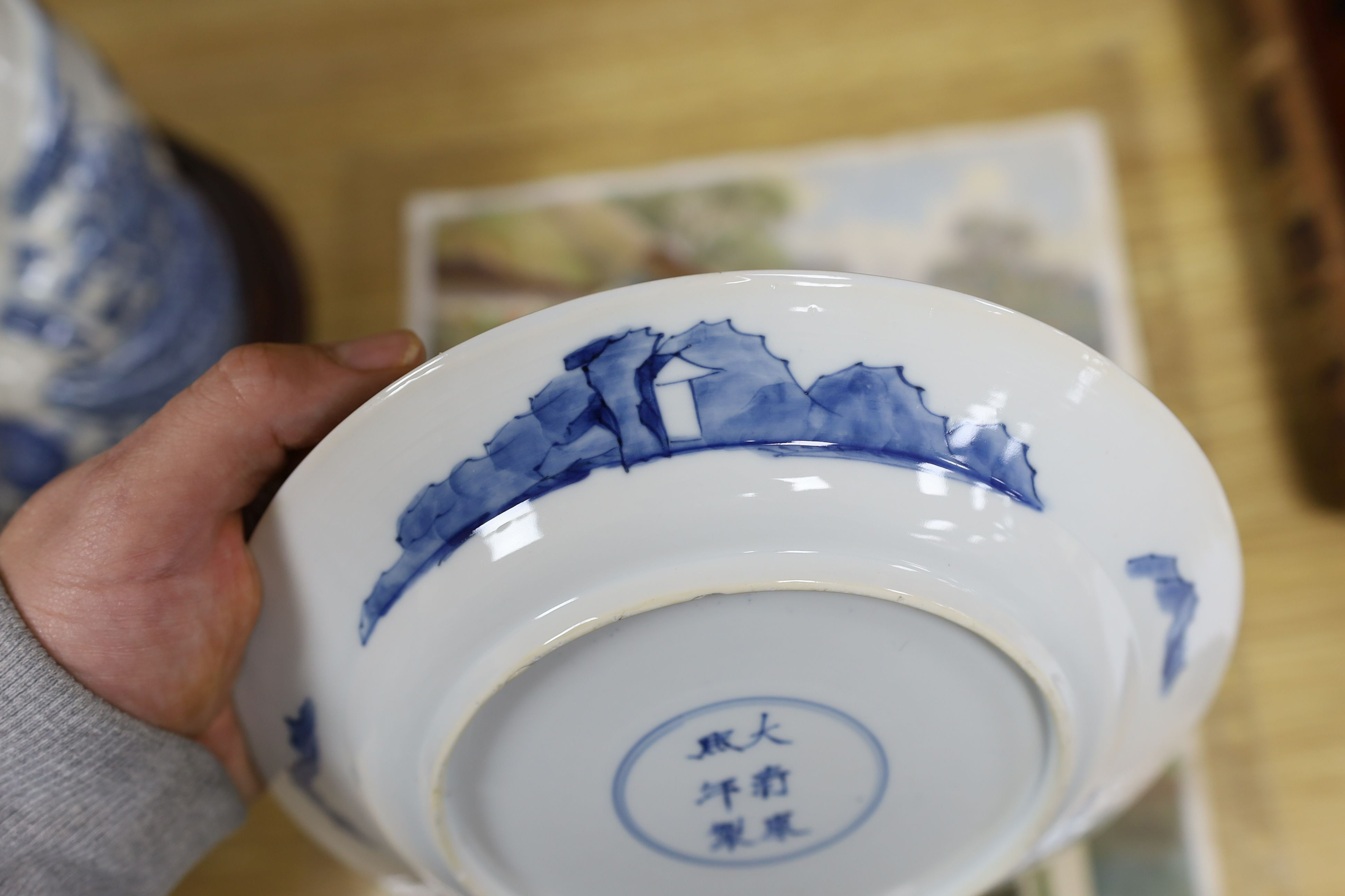 Two Chinese blue and white plates, Kangxi period, one with Kangxi mark the other a Chenghua mark, 21 cms diameter